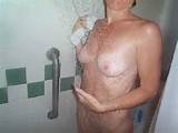 All wet and looking sexy is this blonde milf taking a shower.