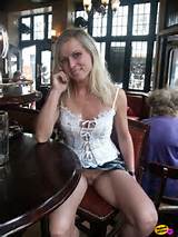 Sexy blonde milf shows her cooter in a restaurant